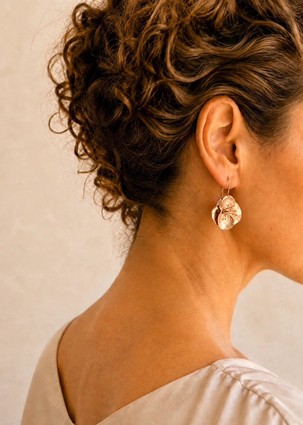Woman wearing handmade flower drop earrings