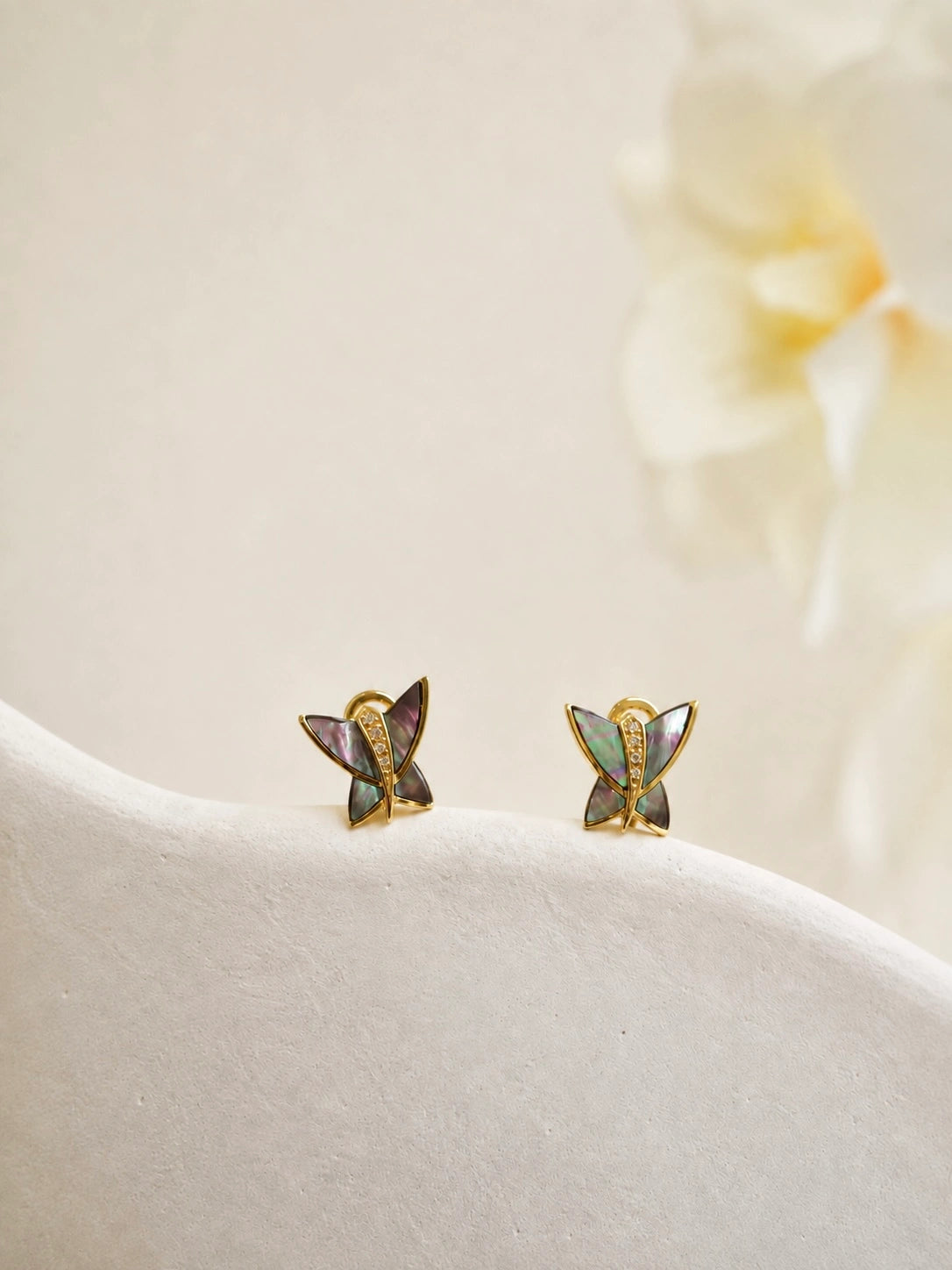 Pair of natural mother of pearl butterfly earrings, close-up