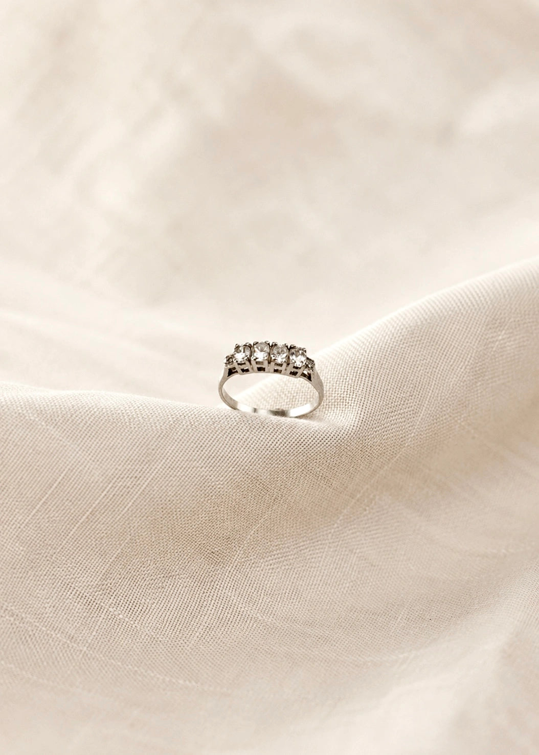 Sterling silver band ring with a graduated row of white zircons