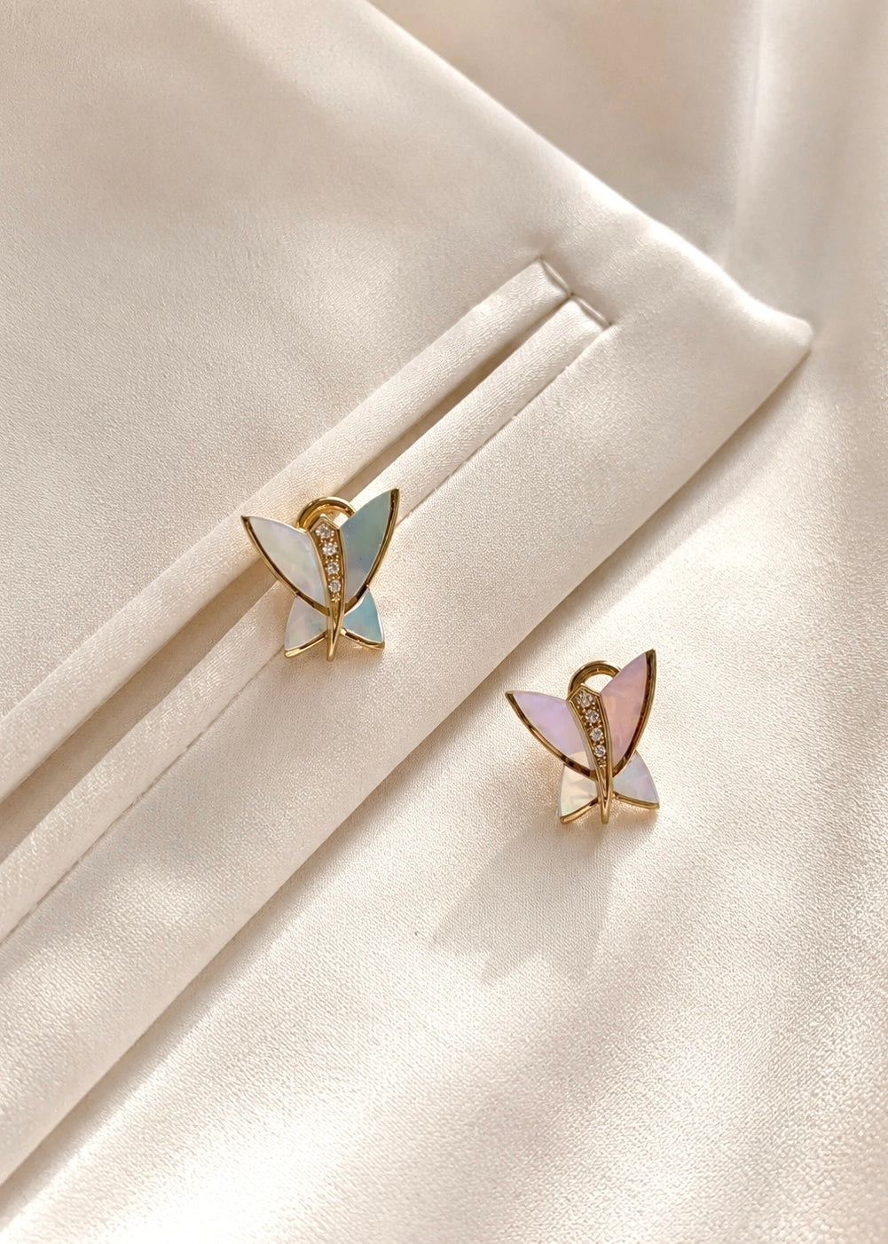 Detail of a butterfly earring with white mother of pearl and white zircons