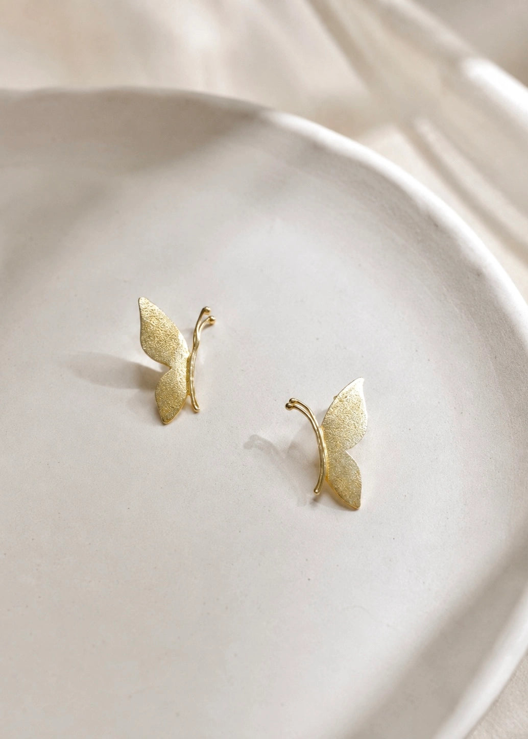 Gold-plated sterling silver 925 butterfly earrings, close-up