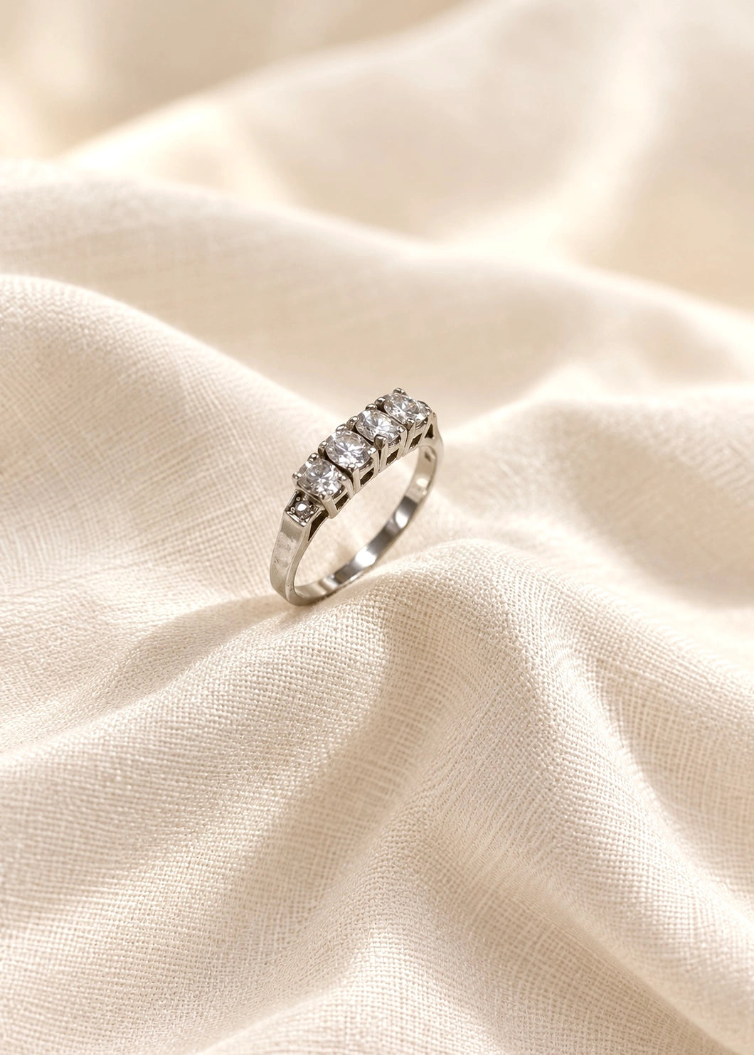 Detail of a sterling silver band ring with six white zircons