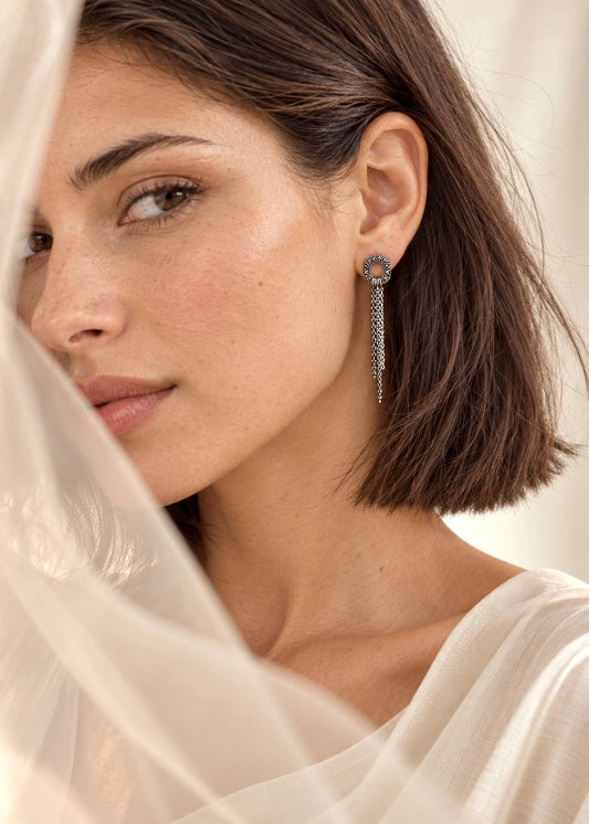 Marcasite drop earrings worn on a woman's ear