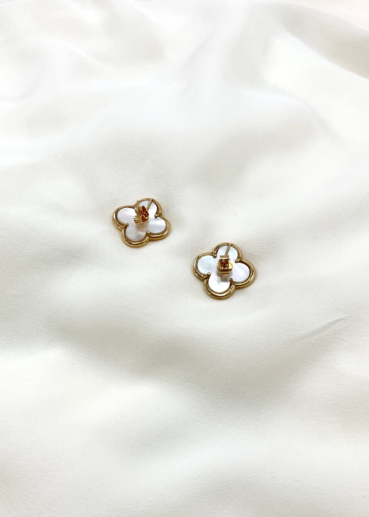 Rear view of mother of pearl four-leaf clover earrings with butterfly backs