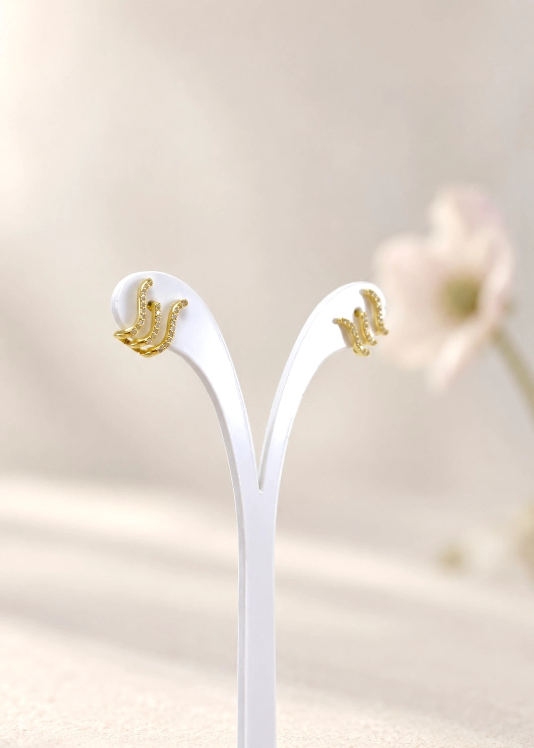 Pair of gold-plated sterling silver wave earrings with white zircons