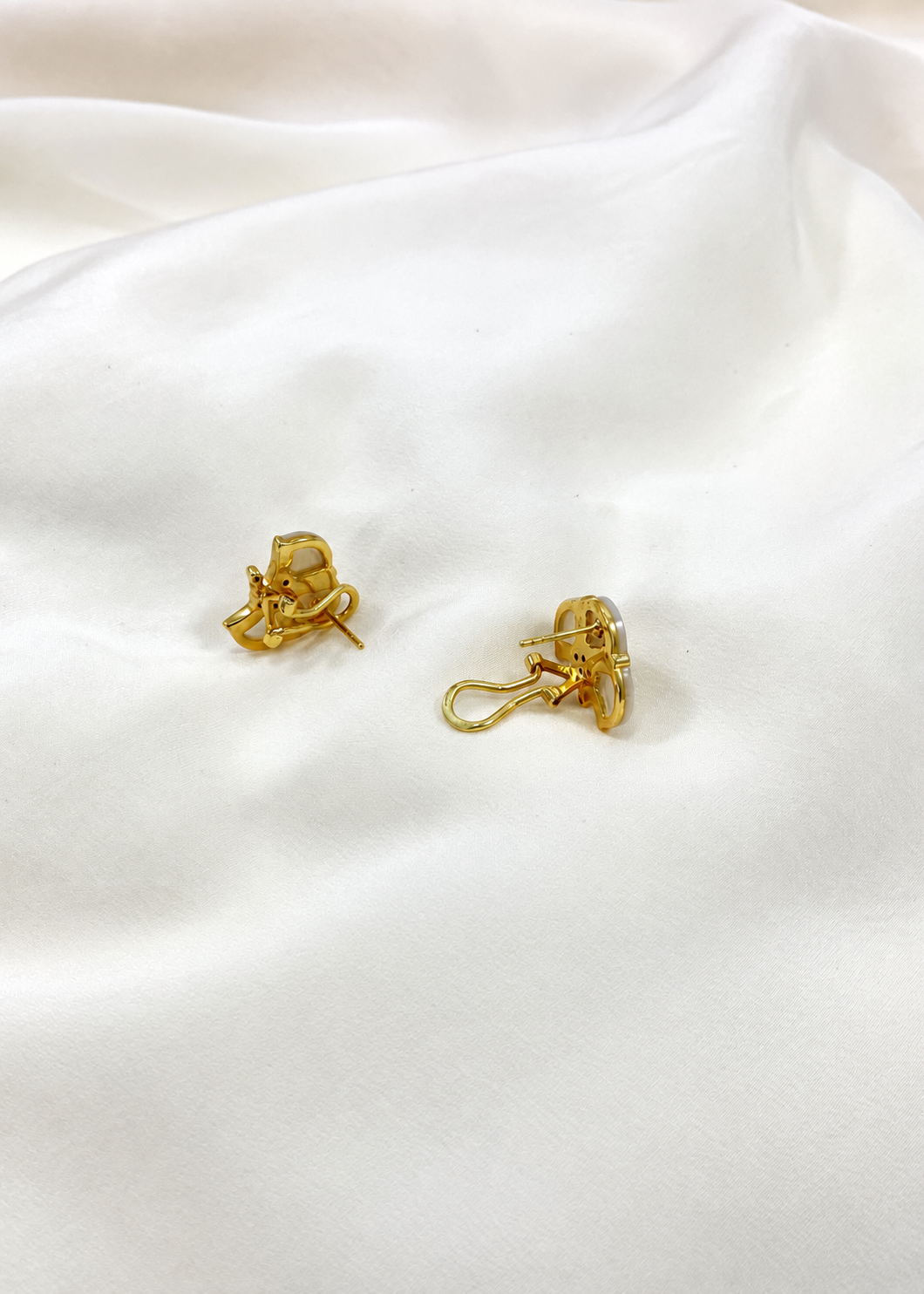 White mother of pearl and white zircon earrings worn on the ear, fit detail